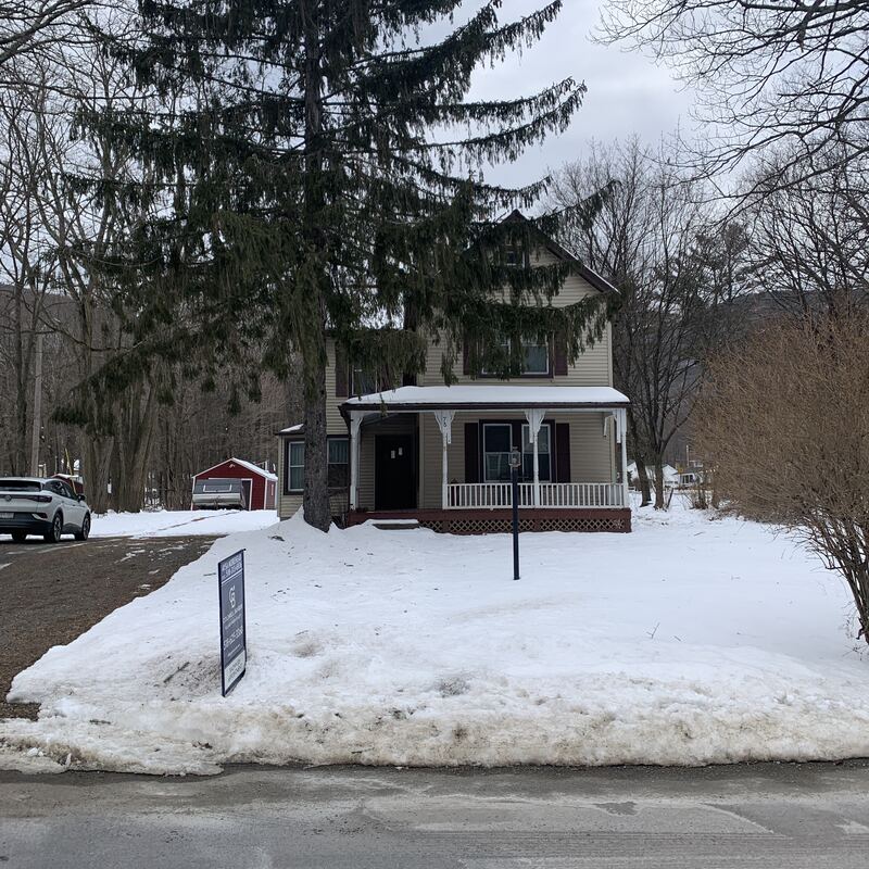 The house before renovation, seen through snow in late winter